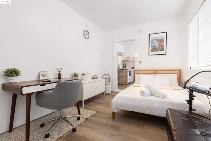 Bedroom featuring light wood-style flooring and a desk