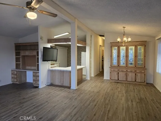 living room office nook on left, built in hutch in dining area, breakfast counter to kitchen.