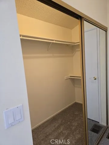 mirrored doors in master walk in closet