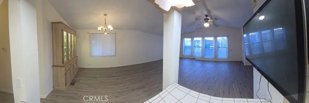 from kitchen breakfast counter, towards dining area built in hutch and living room.