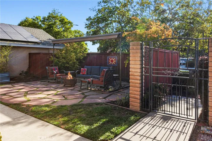 Great patio in front yard with fire pit and canopy/pergola