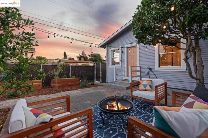 Patio terrace at dusk with a patio and an outdoor living space with a fire pit