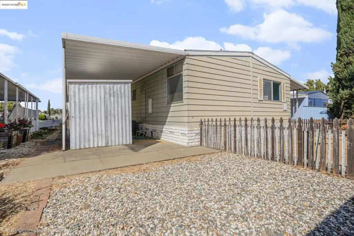 View of side of property with a carport