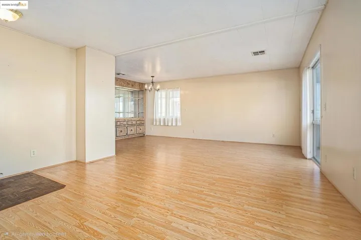Spare room featuring light wood finished floors and suspended lighting