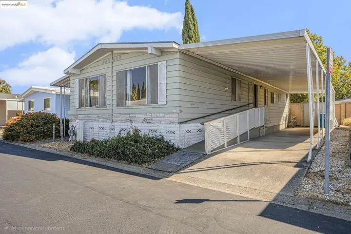View of front of home featuring a carport and driveway