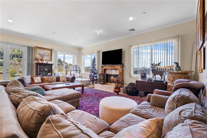 Family Room Fireplace and French doors to Backyard.