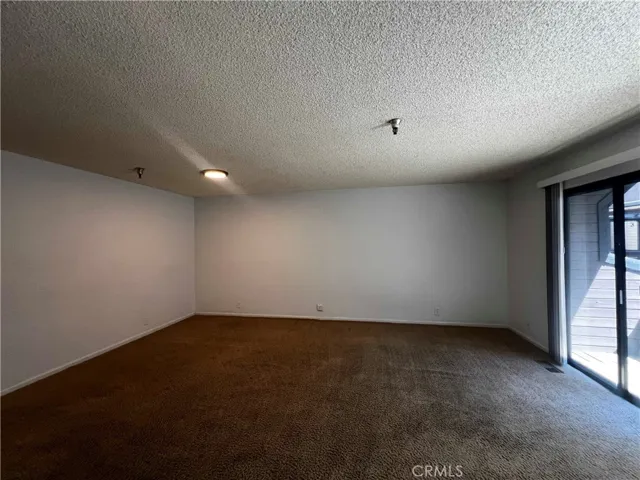 Large living room with slider out to the balcony.