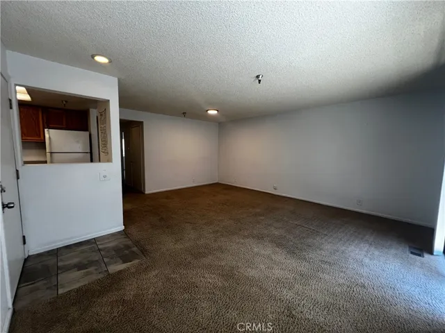 Entry on the left, pass through window to the kitchen and the large living room to the right.