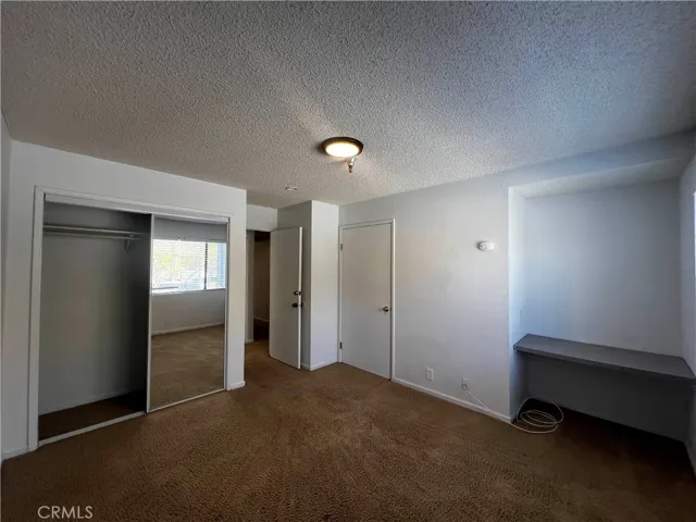 Bedroom with closet and built-in desk.
