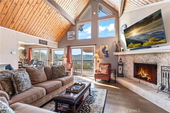 Floor to ceiling fireplace and windows with lake views.