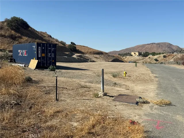 The flat area with the storage container is not part of this land.