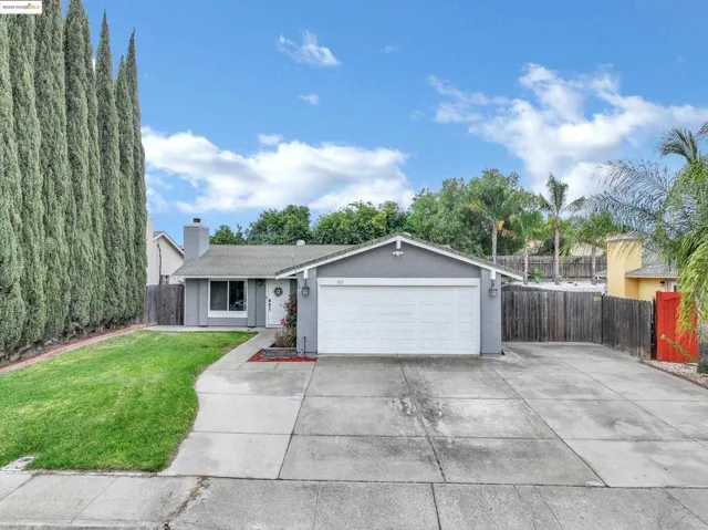 Single story home with driveway, a chimney, a garage, and stucco siding