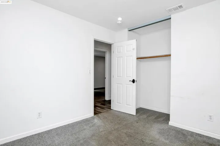 Unfurnished bedroom featuring carpet and a closet