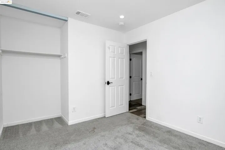 Unfurnished bedroom with carpet floors and baseboards