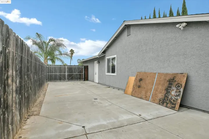 Fenced backyard with a patio area