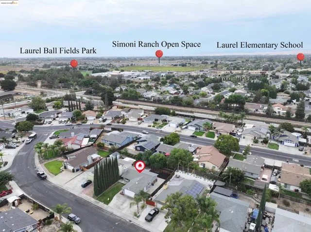 Aerial view of property and surrounding area featuring nearby suburban area