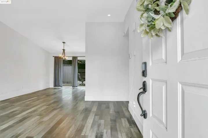 Foyer entrance featuring wood finished floors, a chandelier, and recessed lighting