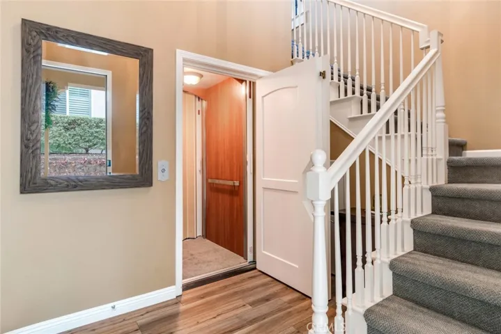 Elevator Door and Stairwell Greet You Upon Entry; Your Choice? Living Areas Are On One-Level-Upstairs