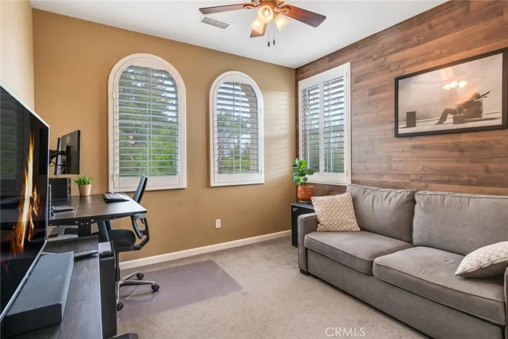 Front-Facing Guest Bedroom Has Plantation Shutters & A Fan/Light To Control Lighting. Note Novel Laminate Covering On Wall