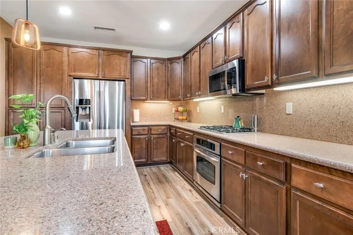 Beautiful Large Kitchen With Double Stainless Sink, Large Island & Lush Dark Wood Cabinetry