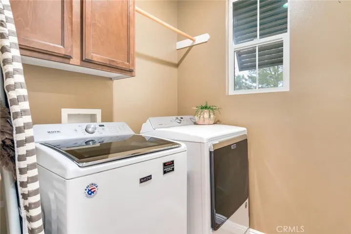 Indoor Laundry Room Has Exhaust Fan And Shaded Window, Plus Storage Cabinet: Both Gas & Electric Hook-Ups