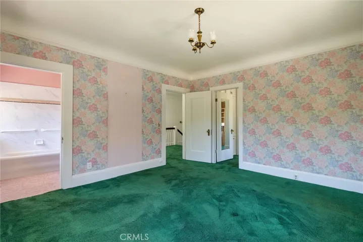 Primary suite with attached sitting room/closet next to access door.  Ensuite bathroom to the left.