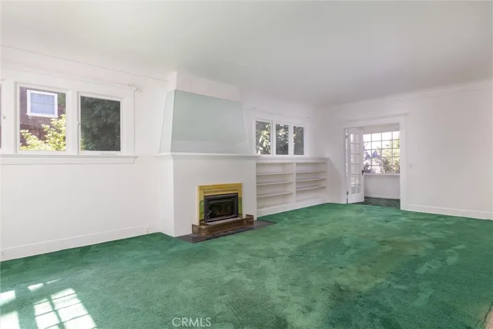 Living room with enclosed back porch at the rear.
