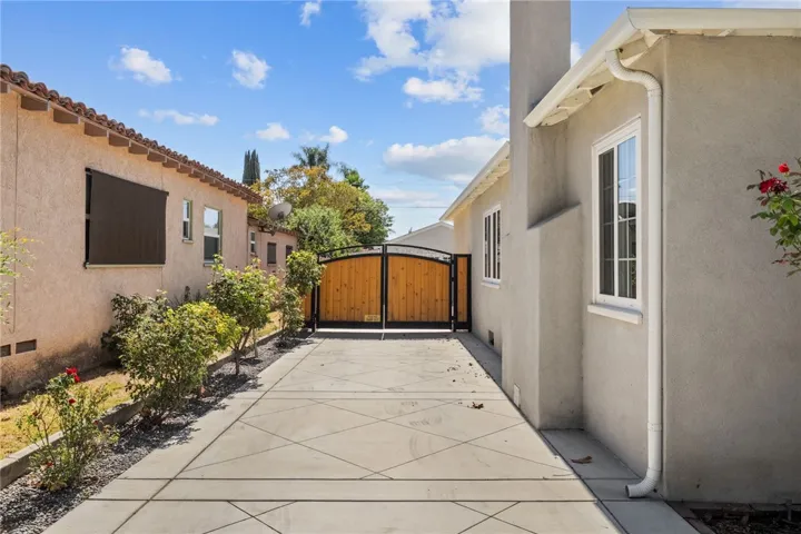 Beautiful driveway with gate leading to detached garage
