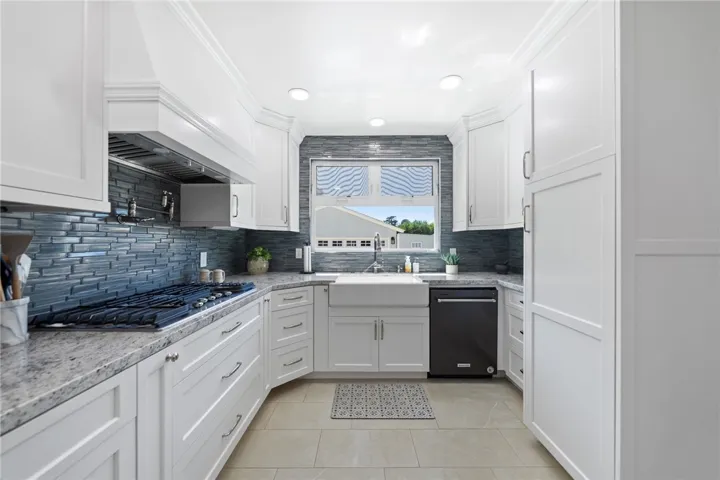 Updated kitchen top to bottom with new windows, shaker cabinets, counter tops, backsplash, vented hood, appliances, etc.