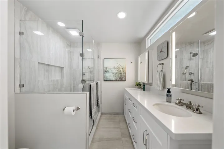Primary bath with double sinks and gorgeous shower and lighted mirrors