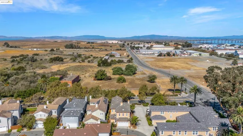 Aerial view of property and surrounding area featuring a mountainous background
