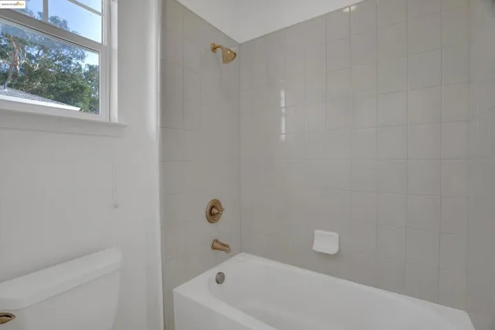 Bathroom with bathtub / shower combination and toilet