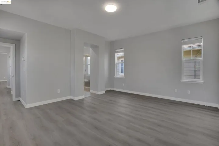Spare room featuring healthy amount of natural light and light wood-style flooring