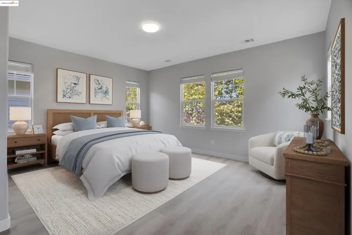 Bedroom with baseboards and wood finished floors