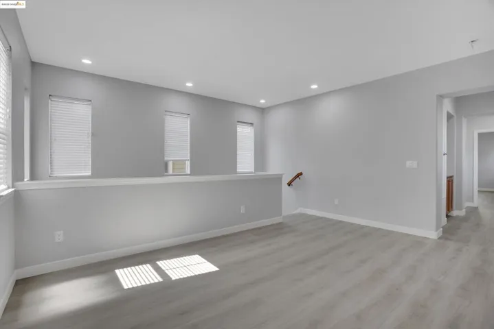 Empty room featuring light wood-style floors and recessed lighting