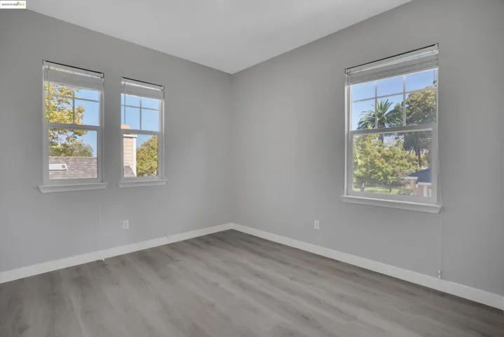Unfurnished room with light wood-type flooring and baseboards