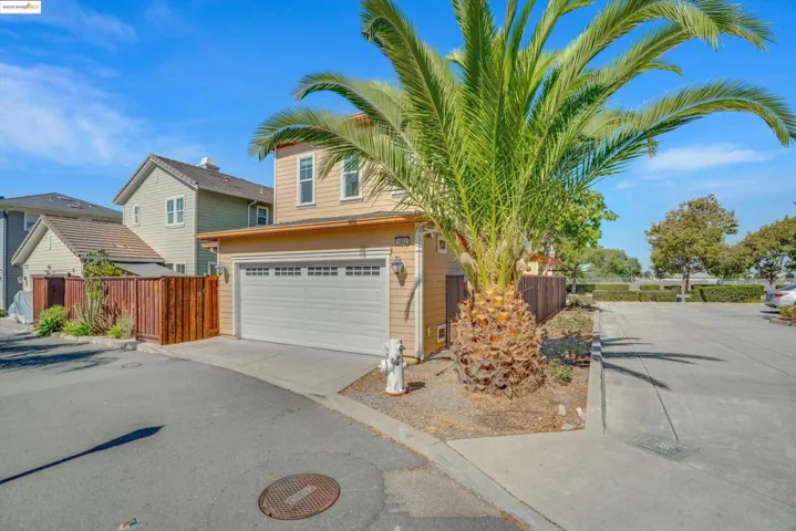 View of front of property featuring concrete driveway and an attached garage