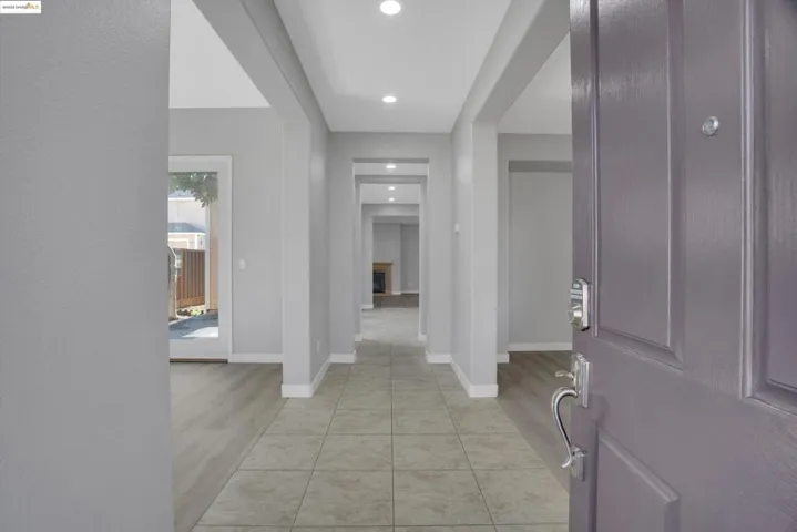 Foyer entrance featuring light tile patterned flooring and recessed lighting