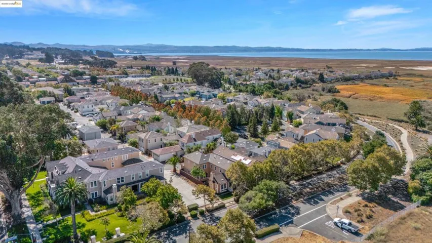 Aerial view of property's location with nearby suburban area and a water and mountain view