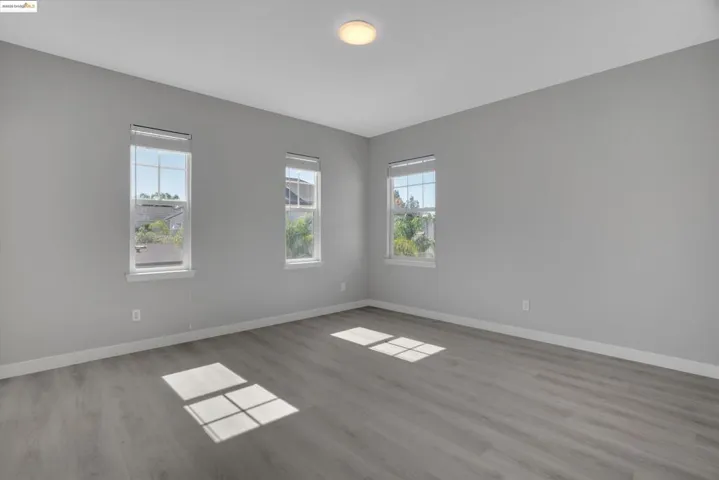 Unfurnished room with light wood finished floors and baseboards