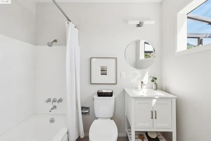 Full bathroom with shower / bath combo and vanity