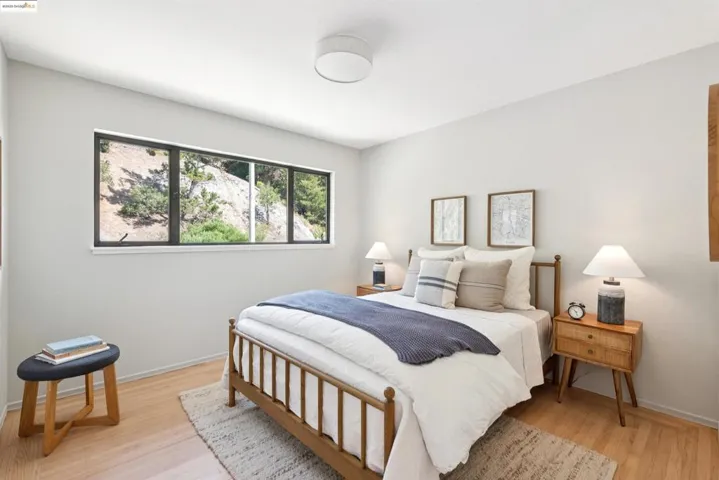 Bedroom with light wood-style flooring and baseboards