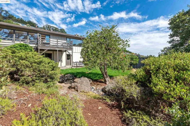 Back of house featuring a patio area and a wooden deck