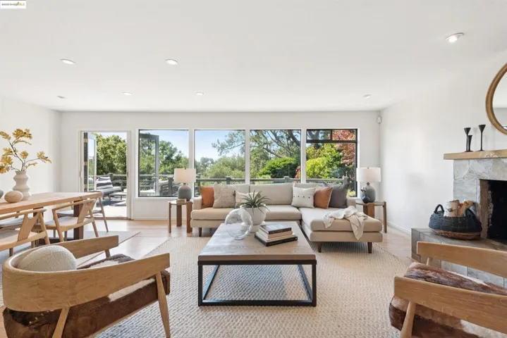 Living area featuring recessed lighting, a fireplace, and light wood finished floors