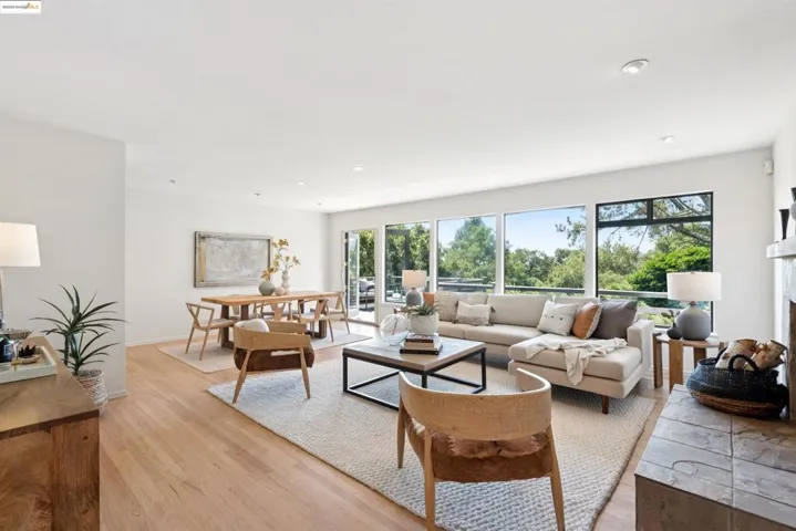 Living room featuring light wood-style floors, a fireplace, and recessed lighting