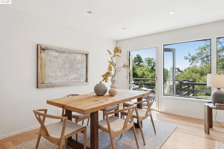 Dining space with light wood-style floors and recessed lighting