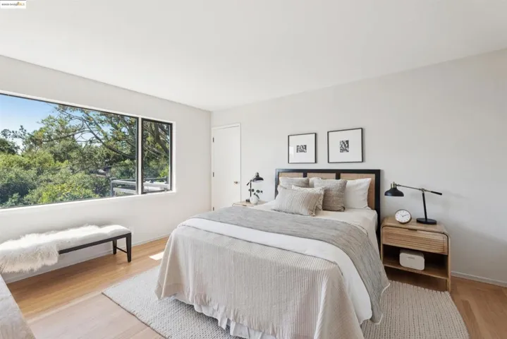 Bedroom with light wood-style floors and baseboards