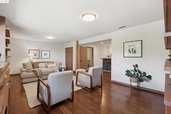 Living room featuring dark wood-style flooring