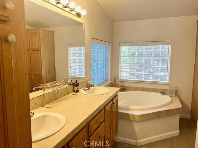 primary bath with dual vanity and soaking tub