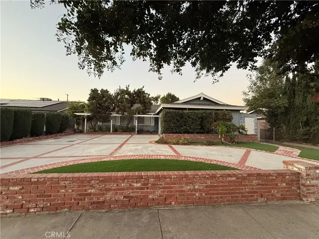 Circular Brick lined driveway enhances this lovely home